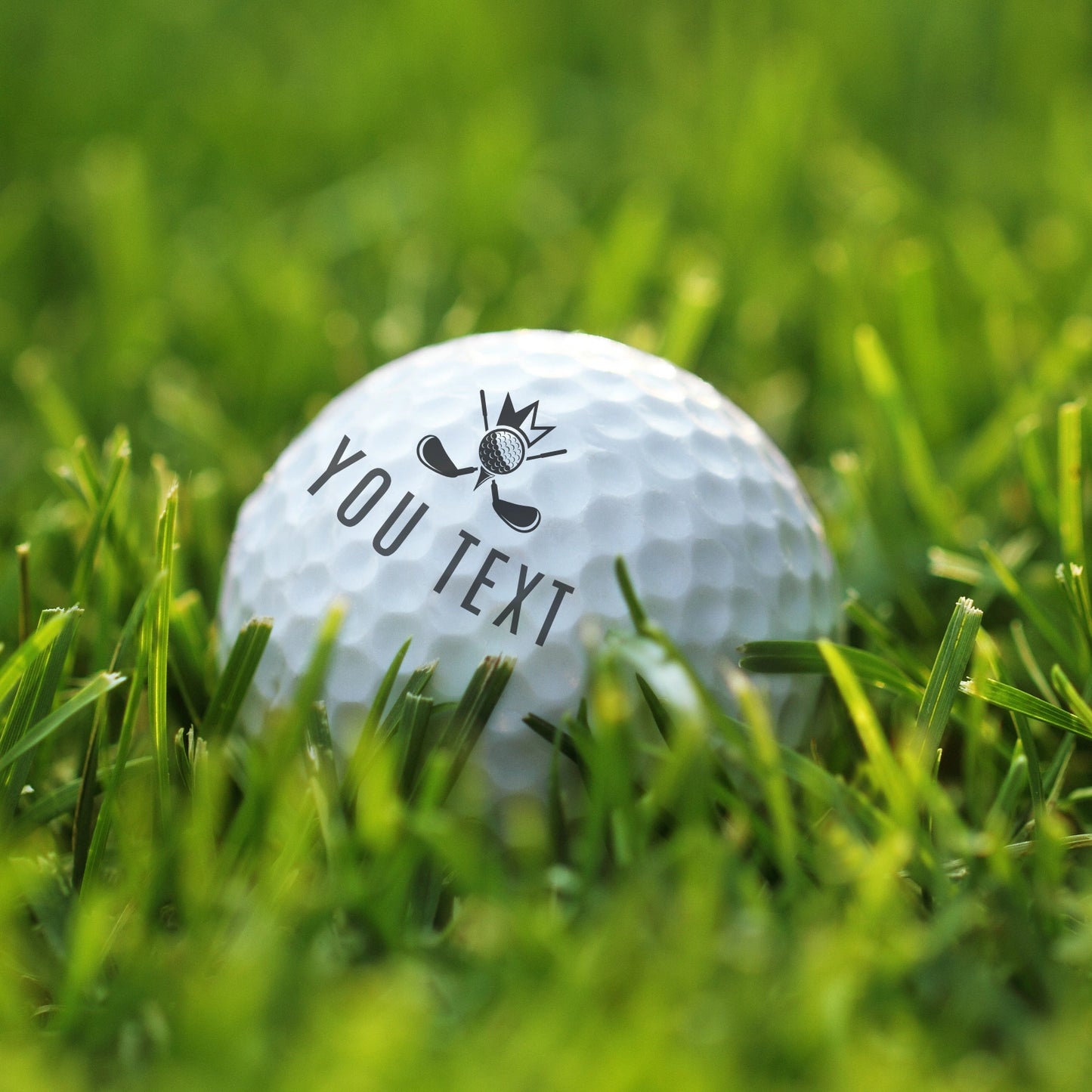 Person using a personalized golf ball stamp to imprint their initials onto a white golf ball.
